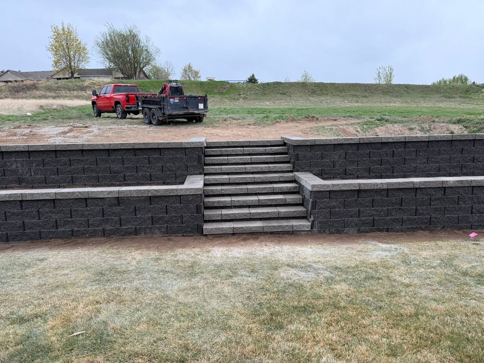 Two-tier charcoal block retaining wall with built-in steps